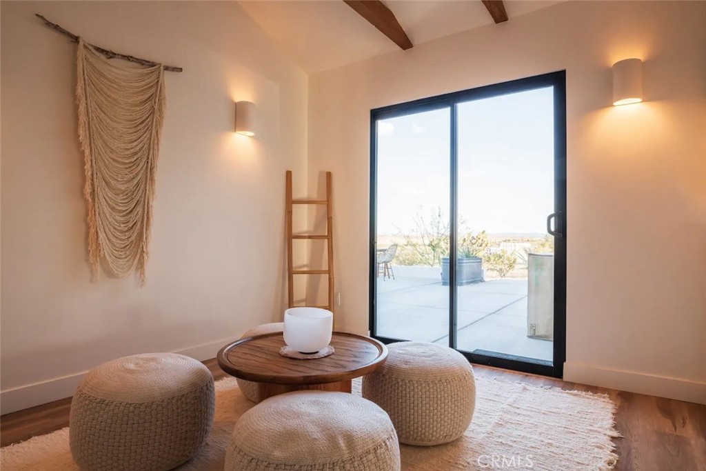 571 Ripon Avenue Yucca Valley, CA 92284 - Photo 14 of 43 a living room with furniture and a floor to ceiling window