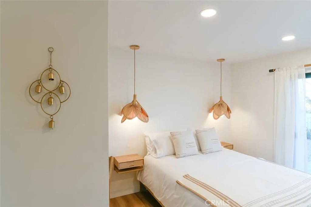 571 Ripon Avenue Yucca Valley, CA 92284 - Photo 24 of 43 a bedroom with a bed and a chandelier