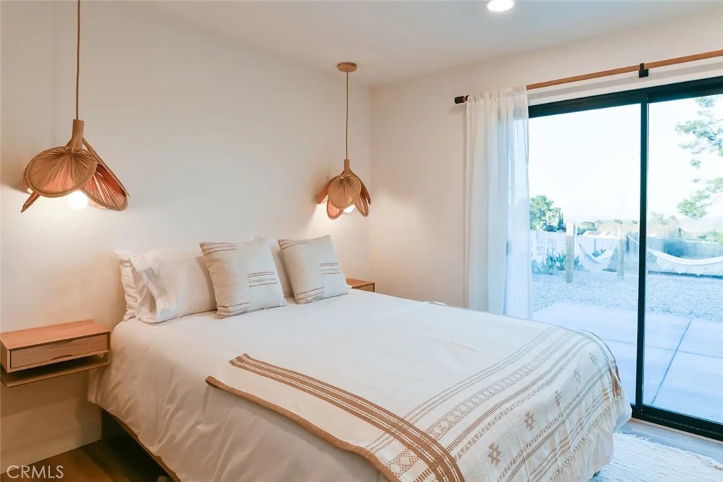 571 Ripon Avenue Yucca Valley, CA 92284 - Photo 30 of 43 a bedroom with a large bed and a window