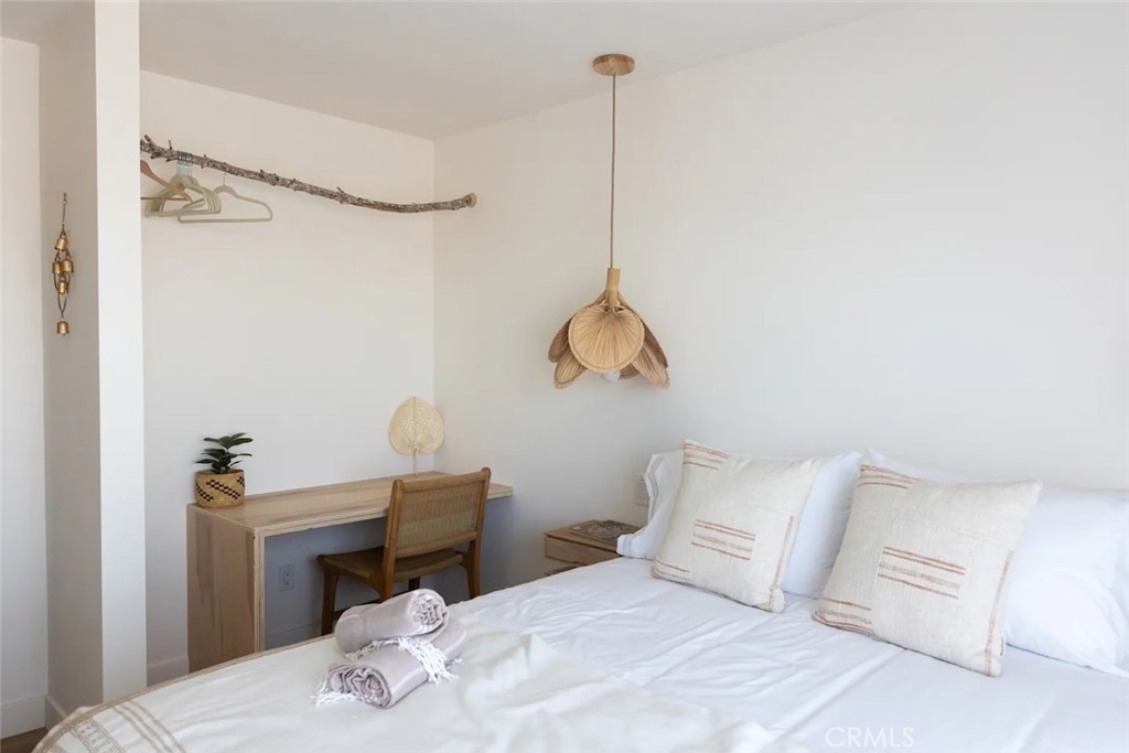 571 Ripon Avenue Yucca Valley, CA 92284 - Photo 32 of 43 a bedroom with a bed and a table