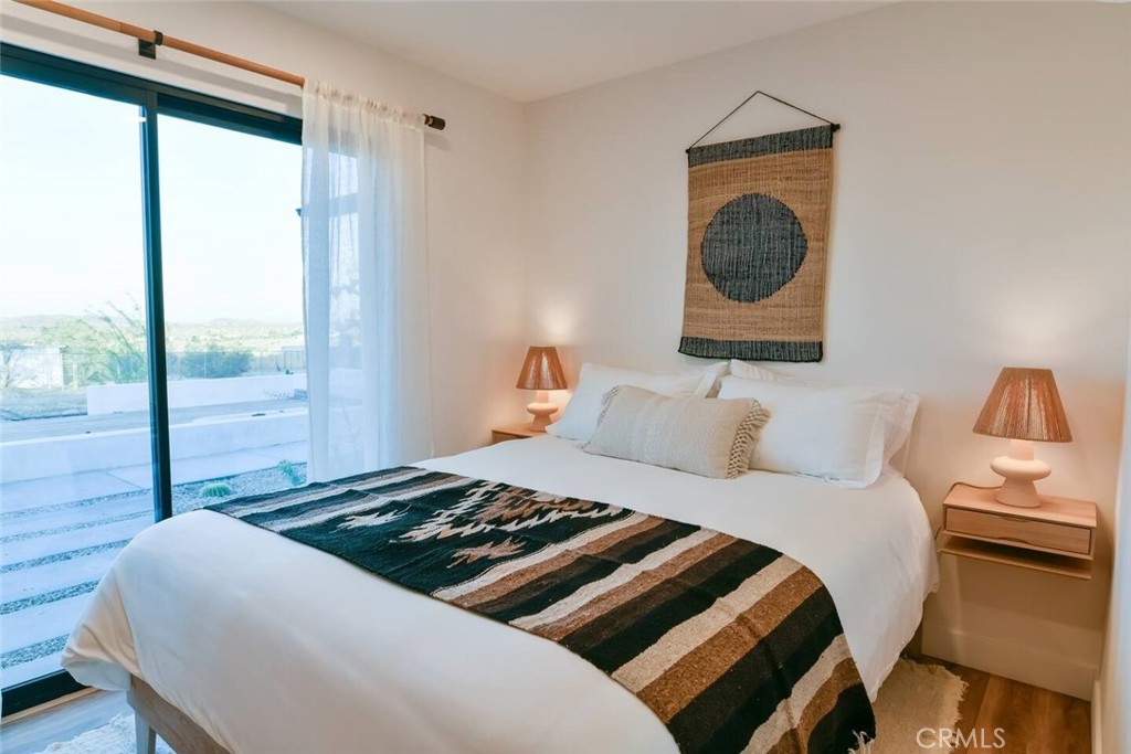 571 Ripon Avenue Yucca Valley, CA 92284 - Photo 37 of 43 a bedroom with a bed and glass window