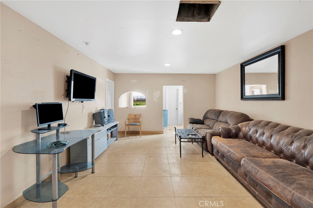 28571 Wild Helendale, CA 92342 - Photo 21 of 22 a living room with furniture and a flat screen tv