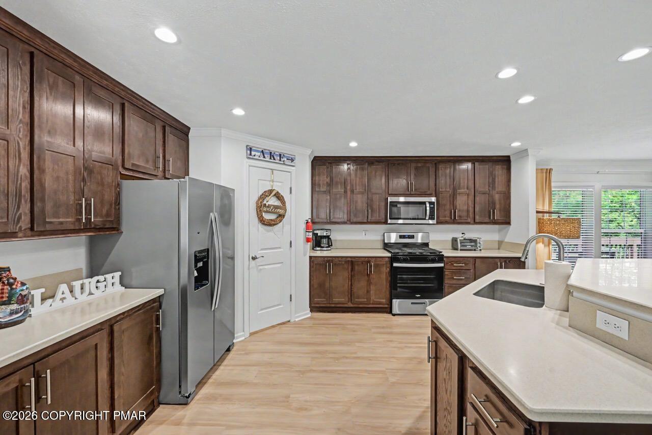 2016 Locust Ridge Road Pocono Lake, PA 18347 - Photo 22 of 82 a kitchen with stainless steel appliances granite countertop a refrigerator stove microwave and sink
