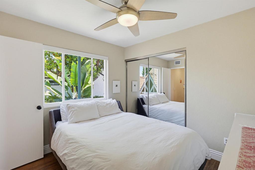 2756 Southampton Road Carlsbad, CA 92010 - Photo 33 of 40 a bedroom with a large bed and a chandelier