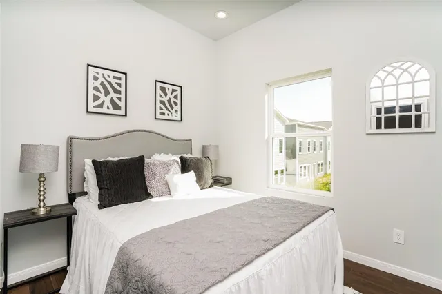 a bedroom with a bed and a window