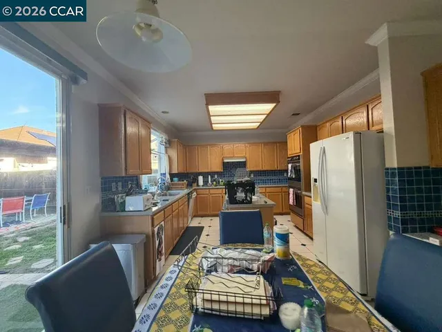 a dining room with furniture and a window