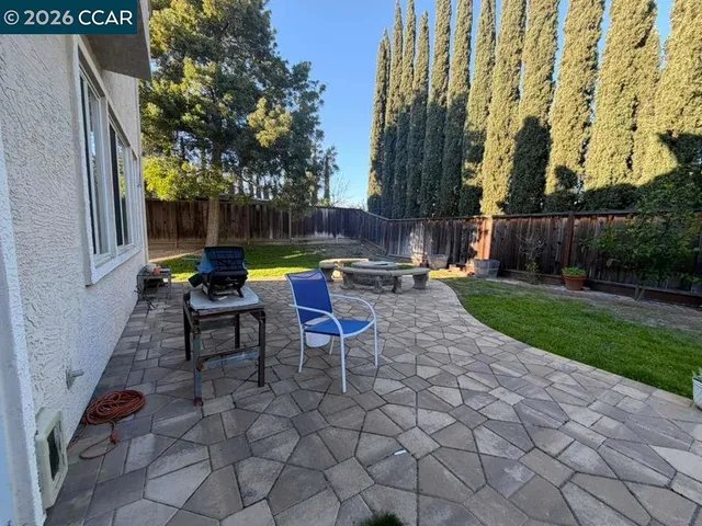 a view of backyard with sitting area