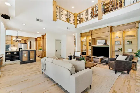 a living room with furniture wooden floor and a flat screen tv