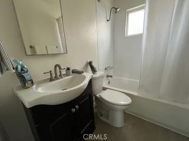 a bathroom with a sink toilet and a mirror