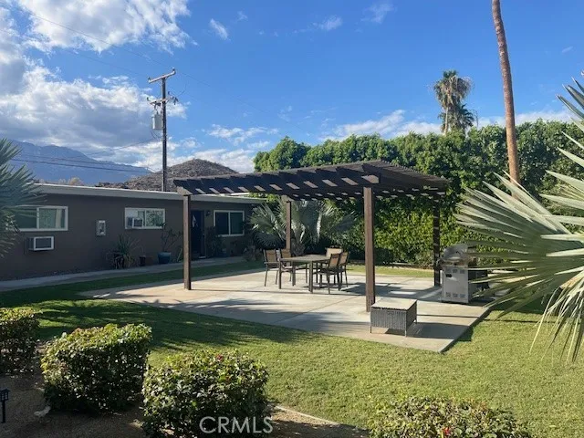 a swimming pool with outdoor seating and yard