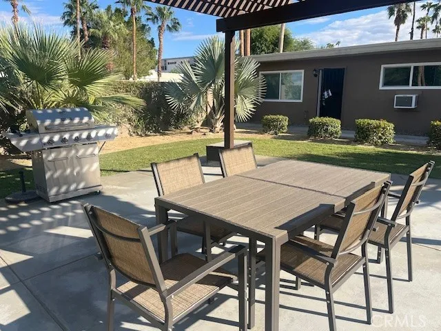 a view of a patio with table and chairs and potted plants