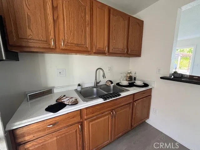 a kitchen with stainless steel appliances granite countertop a sink dishwasher stove and cabinets with wooden floor
