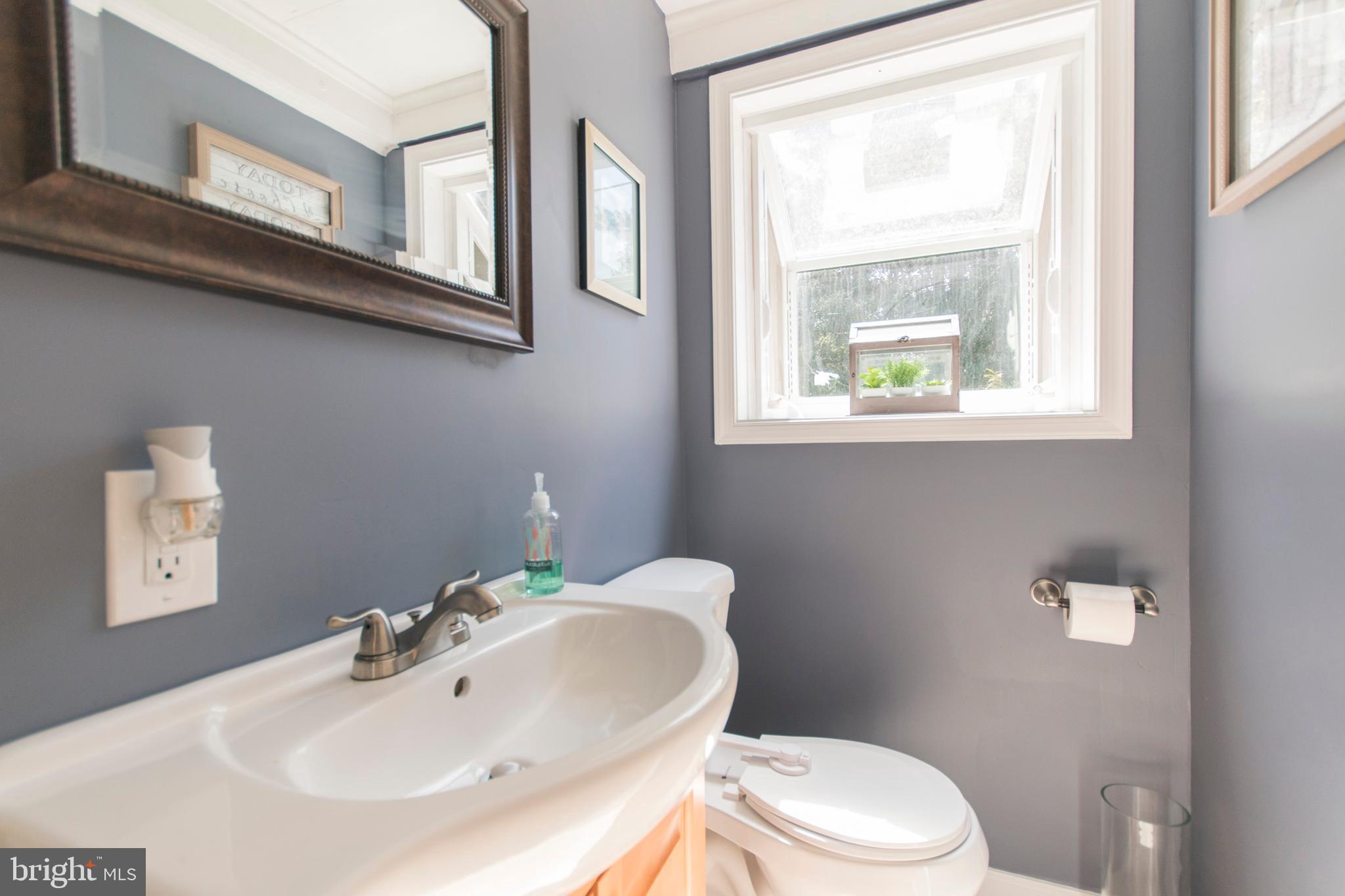 909 Ashbourne Road Cheltenham, PA 19012 - Photo 7 of 36 Main floor powder room with greenhouse window