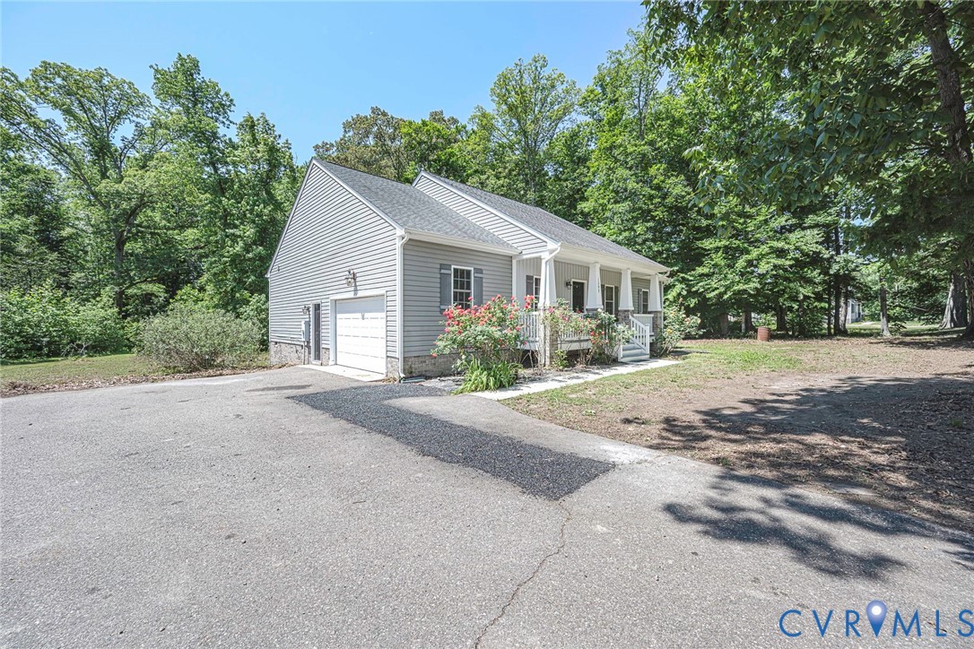 1297 Manfield Road Aylett, VA 23009 - Photo 40 of 41 a view of a house with a yard and large trees