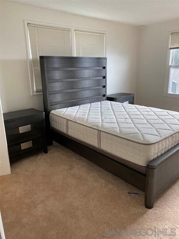 317 Prospect Street La Jolla, CA 92037 - Photo 17 of 24 a bed sitting in a bedroom next to a window