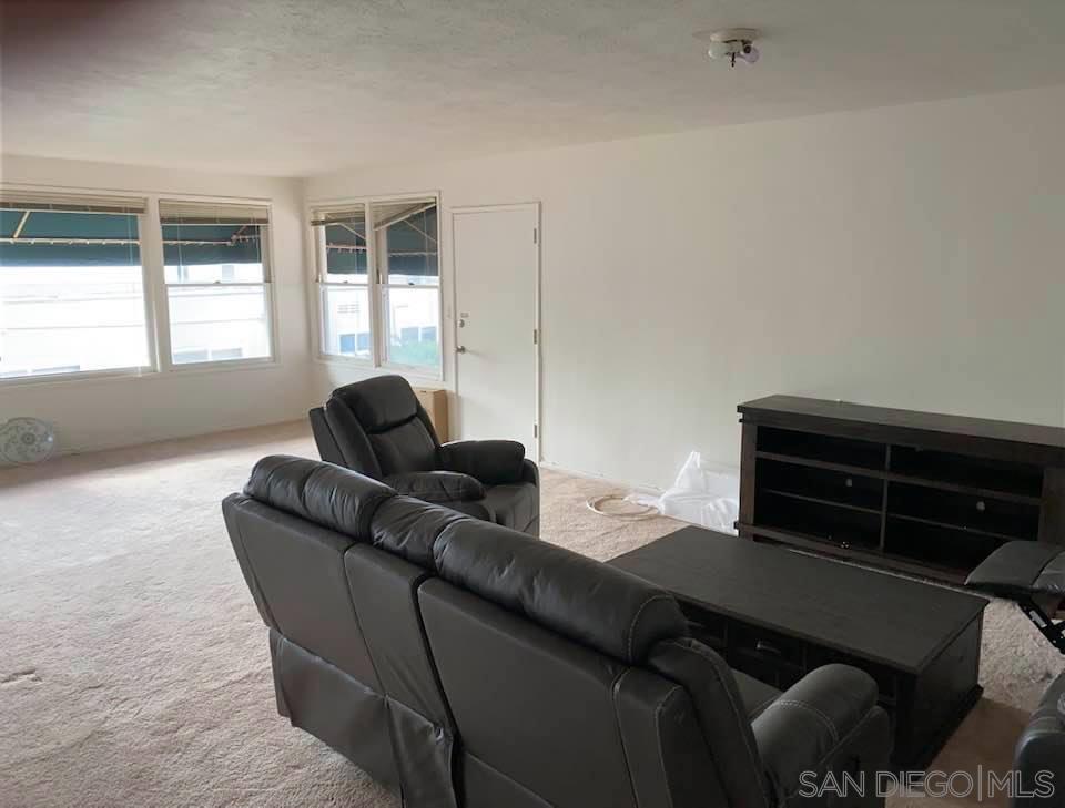317 Prospect Street La Jolla, CA 92037 - Photo 5 of 24 a living room with furniture and a window