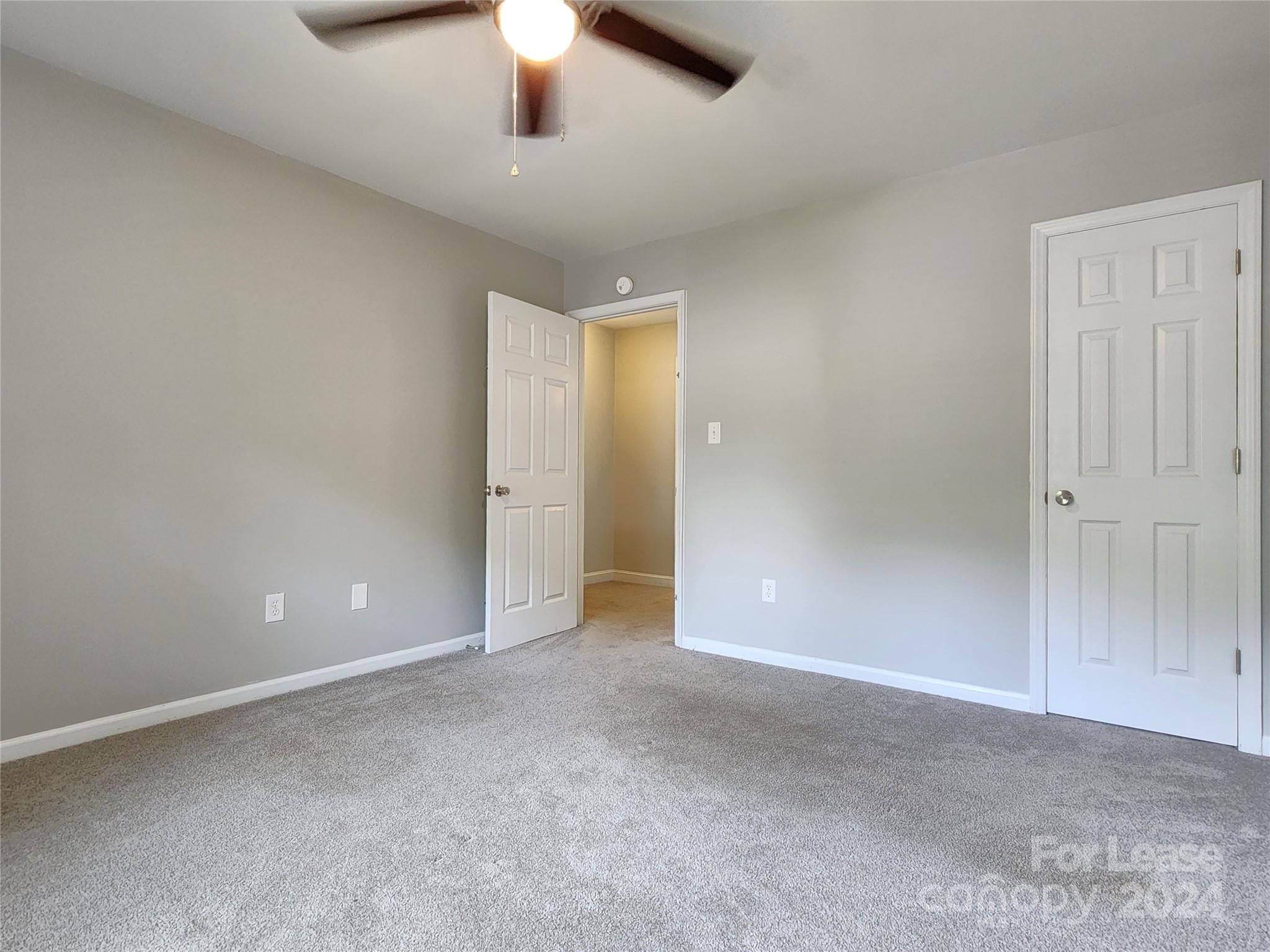 407 Spring Street Northwest, Unit 407 Concord, NC 28025 - Photo 13 of 19 an empty room with chandelier fan