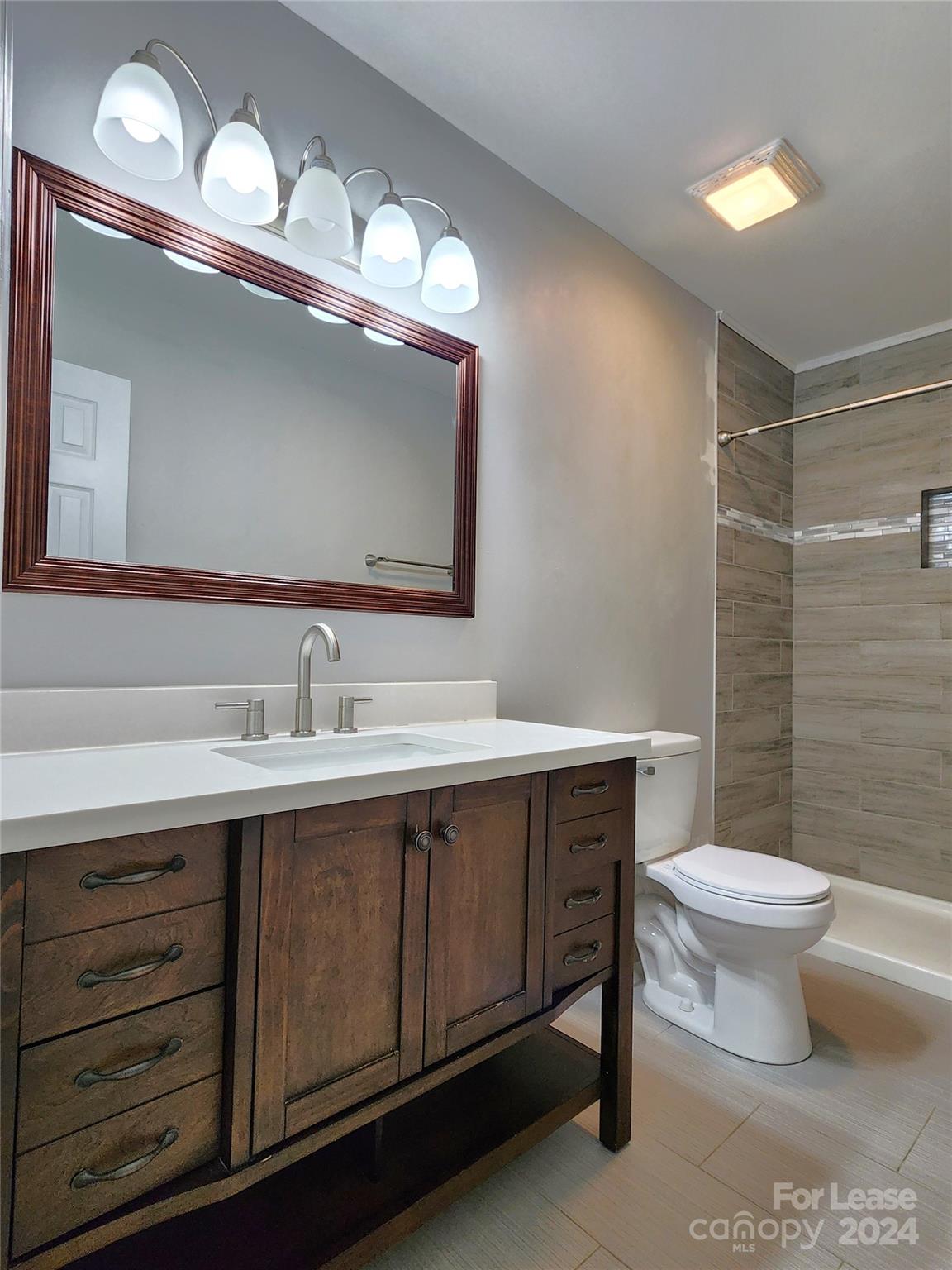 407 Spring Street Northwest, Unit 407 Concord, NC 28025 - Photo 14 of 19 a bathroom with a sink and a mirror