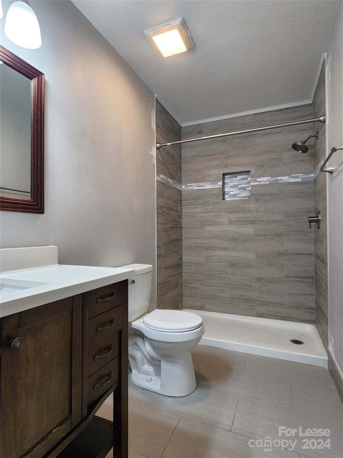 407 Spring Street Northwest, Unit 407 Concord, NC 28025 - Photo 15 of 19 a bathroom with a sink toilet and shower
