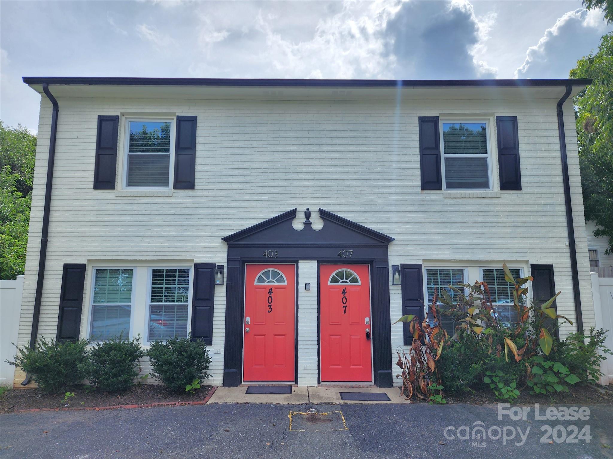 407 Spring Street Northwest, Unit 407 Concord, NC 28025 - Photo 2 of 19 a front view of a house with garden