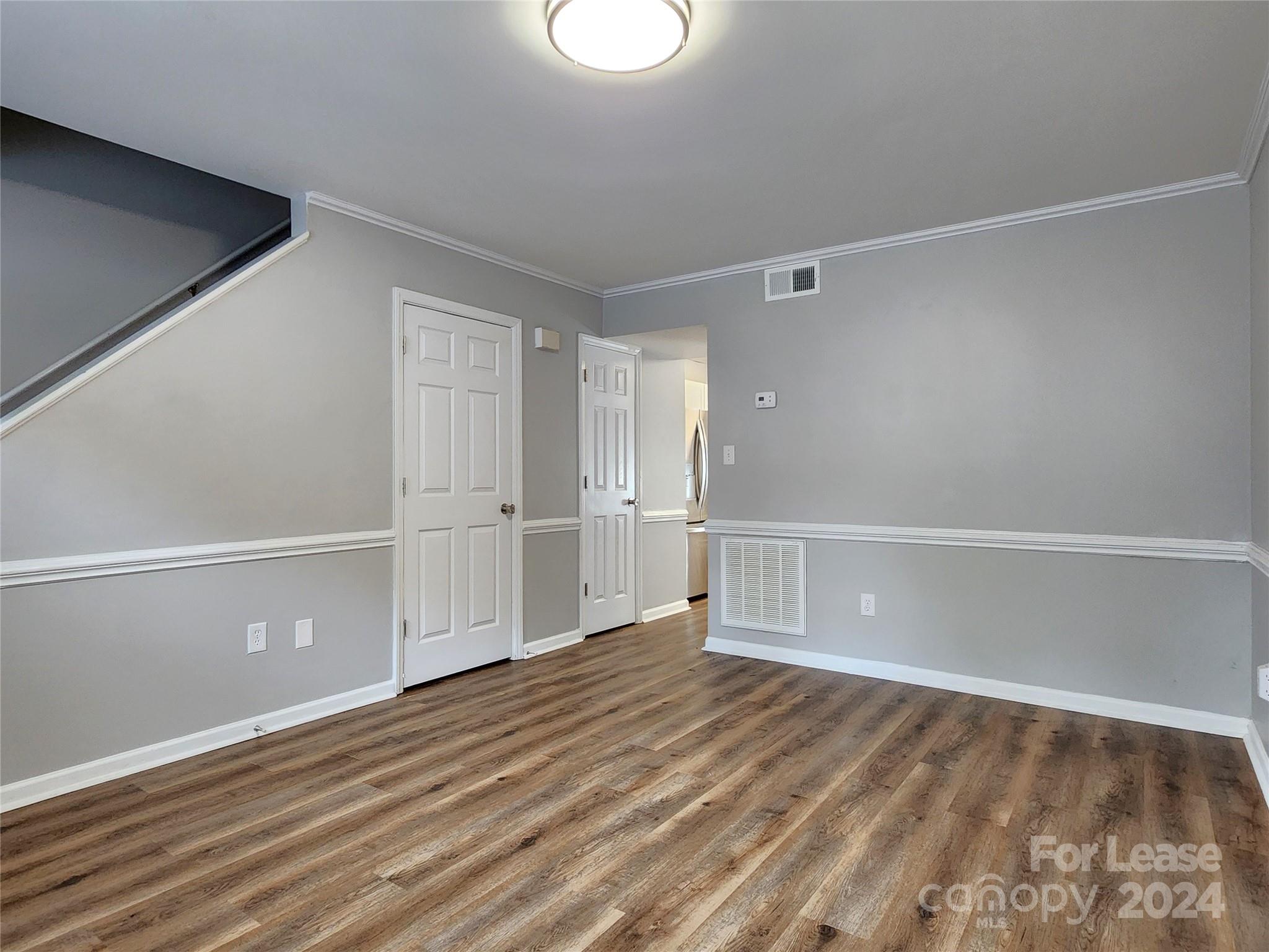 407 Spring Street Northwest, Unit 407 Concord, NC 28025 - Photo 3 of 19 a view of an empty room with wooden floor