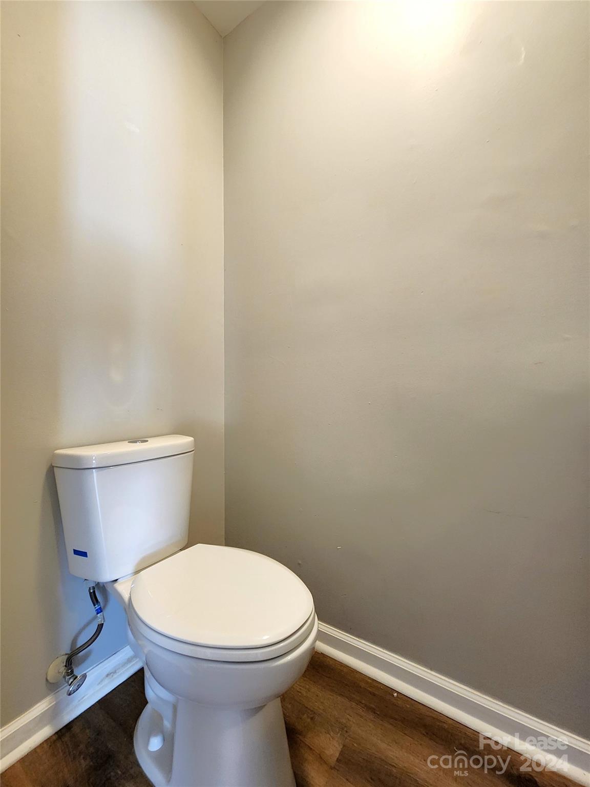 407 Spring Street Northwest, Unit 407 Concord, NC 28025 - Photo 9 of 19 a white toilet sitting next to a white wall