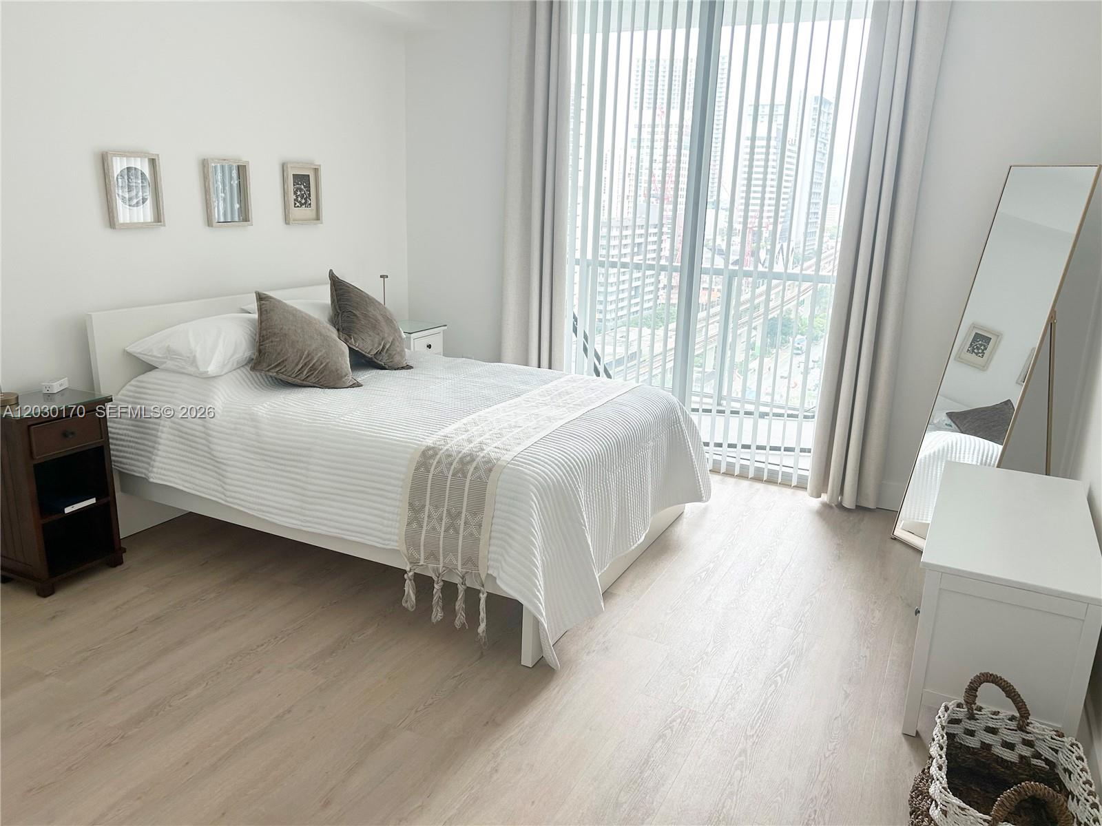 79 Southwest 12th Street, Unit 1710S Miami, FL 33130 - Photo 6 of 25 a bedroom with a bed and a window