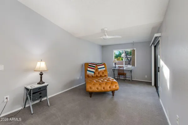 a living room with furniture and a lamp