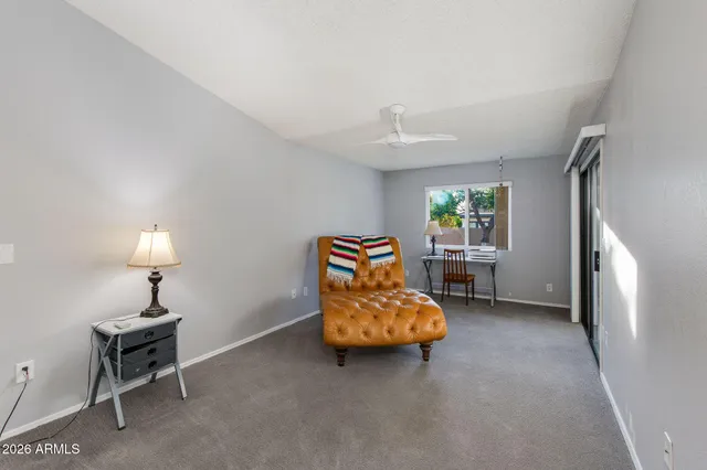 a living room with furniture and a lamp
