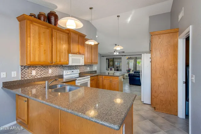 a large kitchen with kitchen island a sink stainless steel appliances and cabinets
