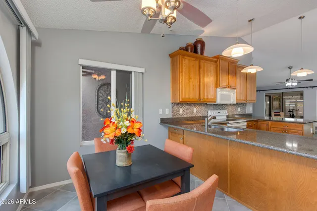 a kitchen with a table and chairs in it
