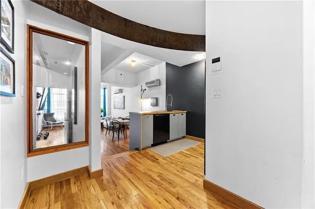 a kitchen with stainless steel appliances kitchen island granite countertop a refrigerator and a sink