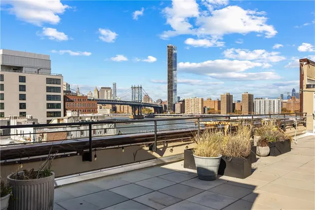 a view of a swimming pool with outdoor seating and city view