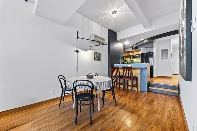 a dining room with furniture and wooden floor