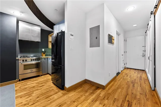 a kitchen with granite countertop a refrigerator and a stove