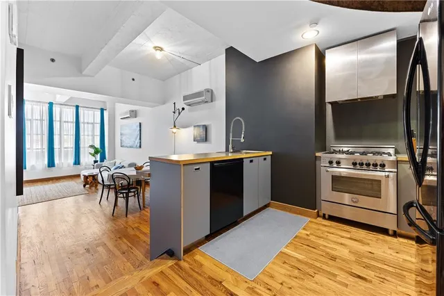 a kitchen with a sink appliances and cabinets