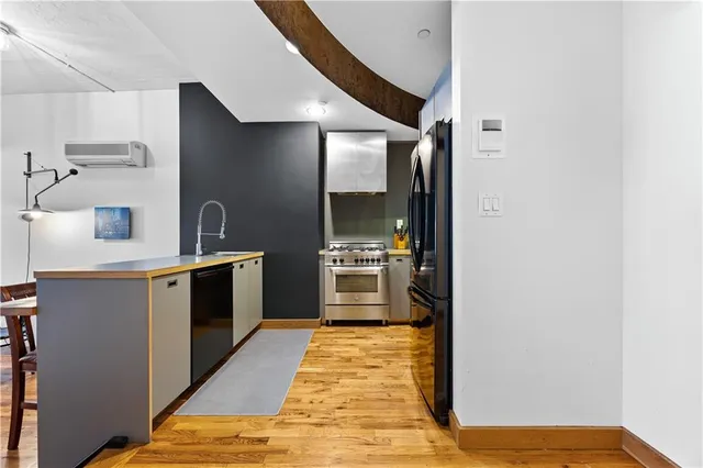 a kitchen with stainless steel appliances granite countertop a stove and a refrigerator