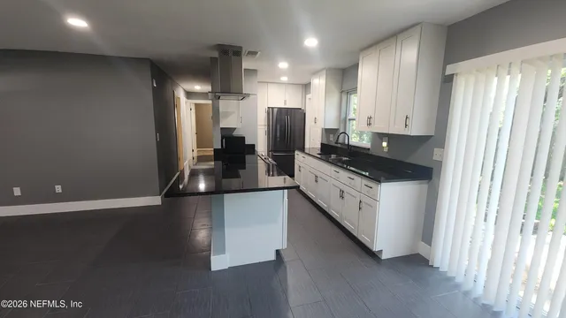 a kitchen with stainless steel appliances a refrigerator sink and stove