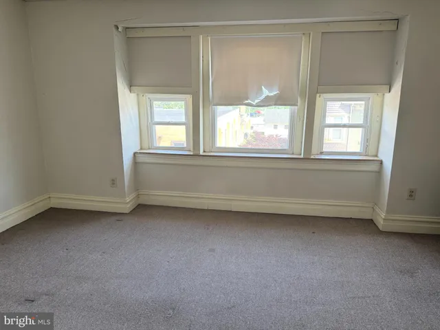 a view of a livingroom with an empty space and window