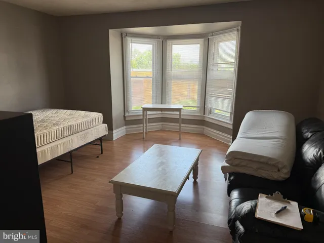 a bedroom with furniture and a window
