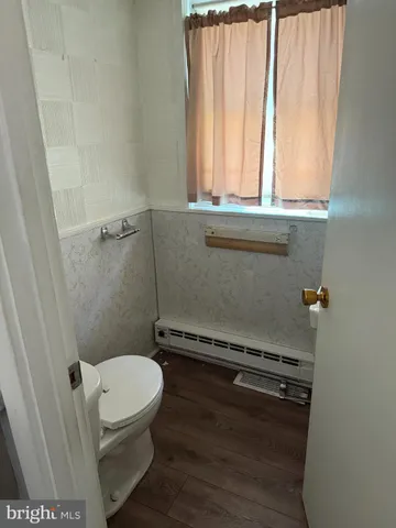 a bathroom with a toilet a sink and a window