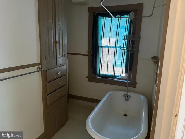 a bathroom with a tub and sink