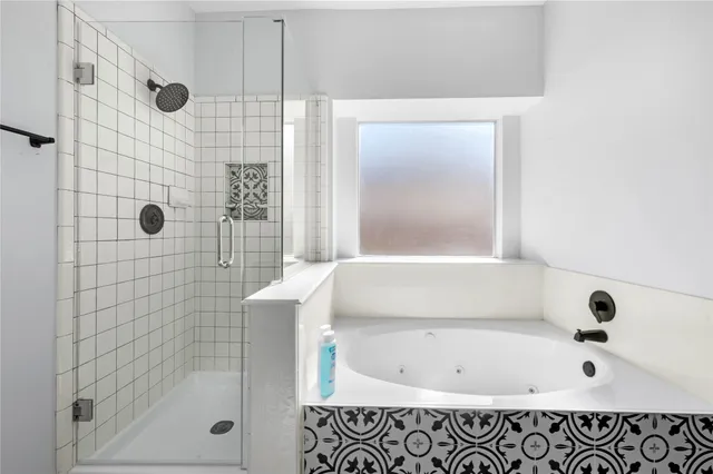 a bathroom with a bathtub and shower