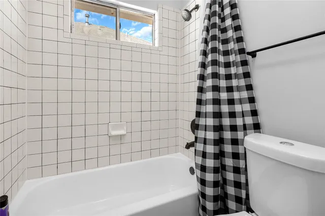 a bathroom with a bathtub and a toilet