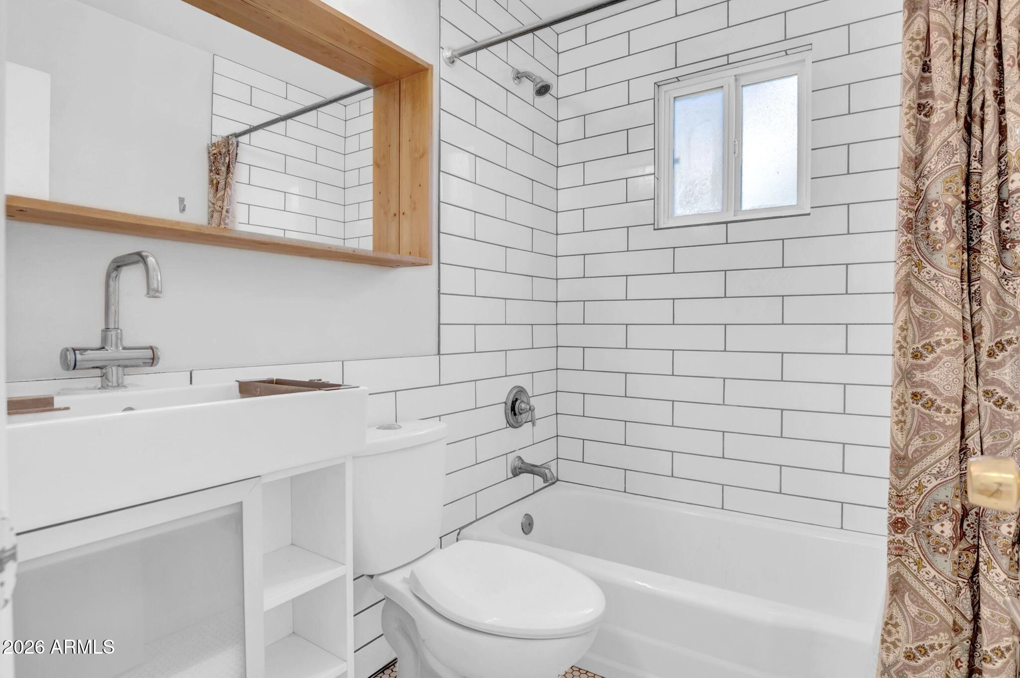 821 North 3rd Street, Unit 8 Phoenix, AZ 85004 - Photo 6 of 10 a bathroom with a bathtub shower sink vanity and toilet