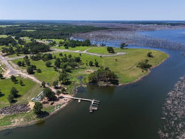 an aerial view of a house with a swimming pool yard and outdoor seating