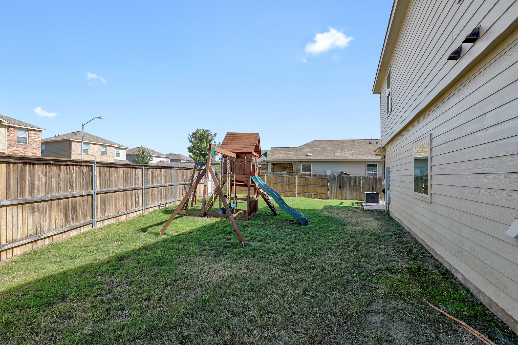 735 Circle Way Jarrell, TX 76537 - Photo 27 of 32 A spacious grassy yard sits securely enclosed by privacy fencing alongside the home.