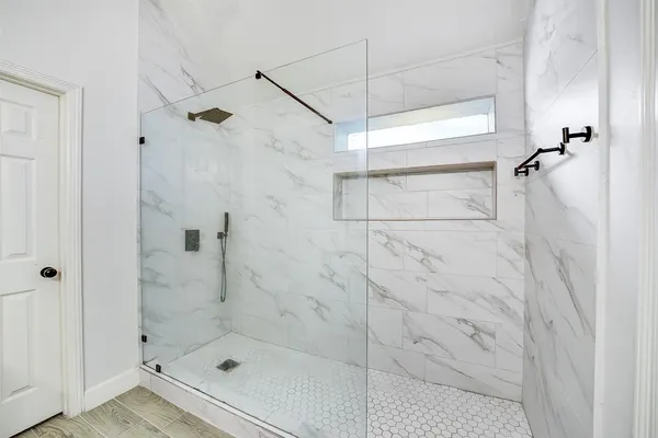 a en suite bathroom with a granite countertop sink and a mirror
