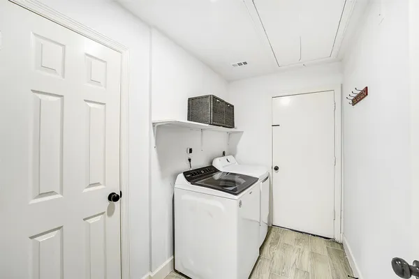 a view of a chair and table in backyard of the house