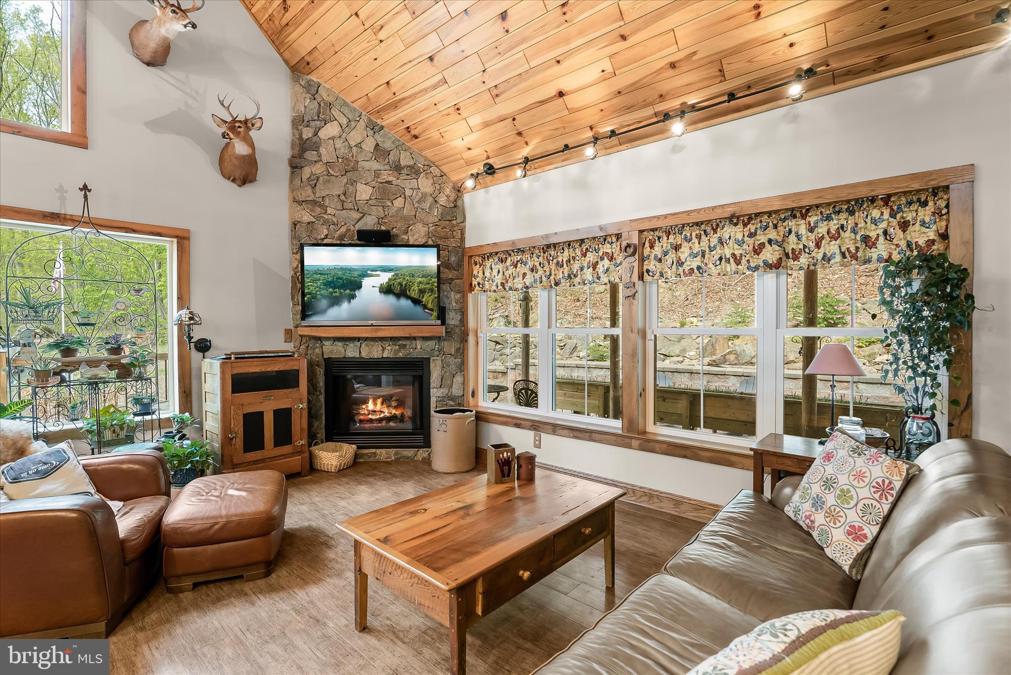 4623 Fishers Hollow Road Myersville, MD 21773 - Photo 15 of 65 a living room with furniture a fireplace and floor to ceiling windows
